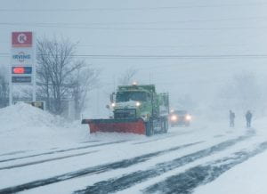 Snow plow in a winter storm